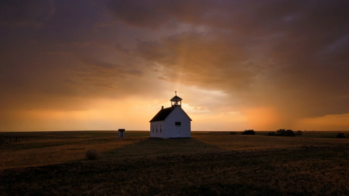 a house with a sunset in the background